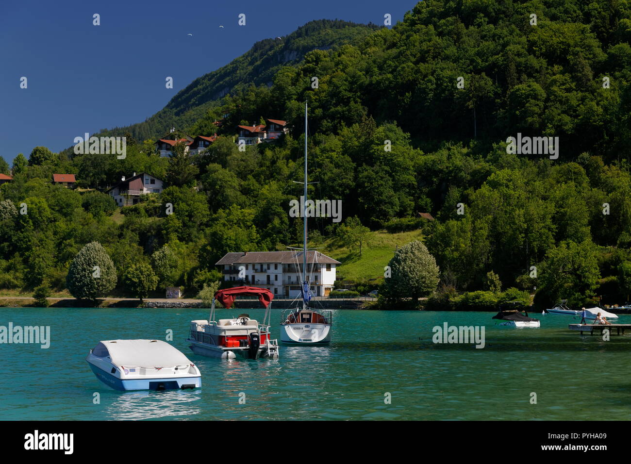Yachts and boats moored on the turqoise shores of Lake Annecy France Stock Photo