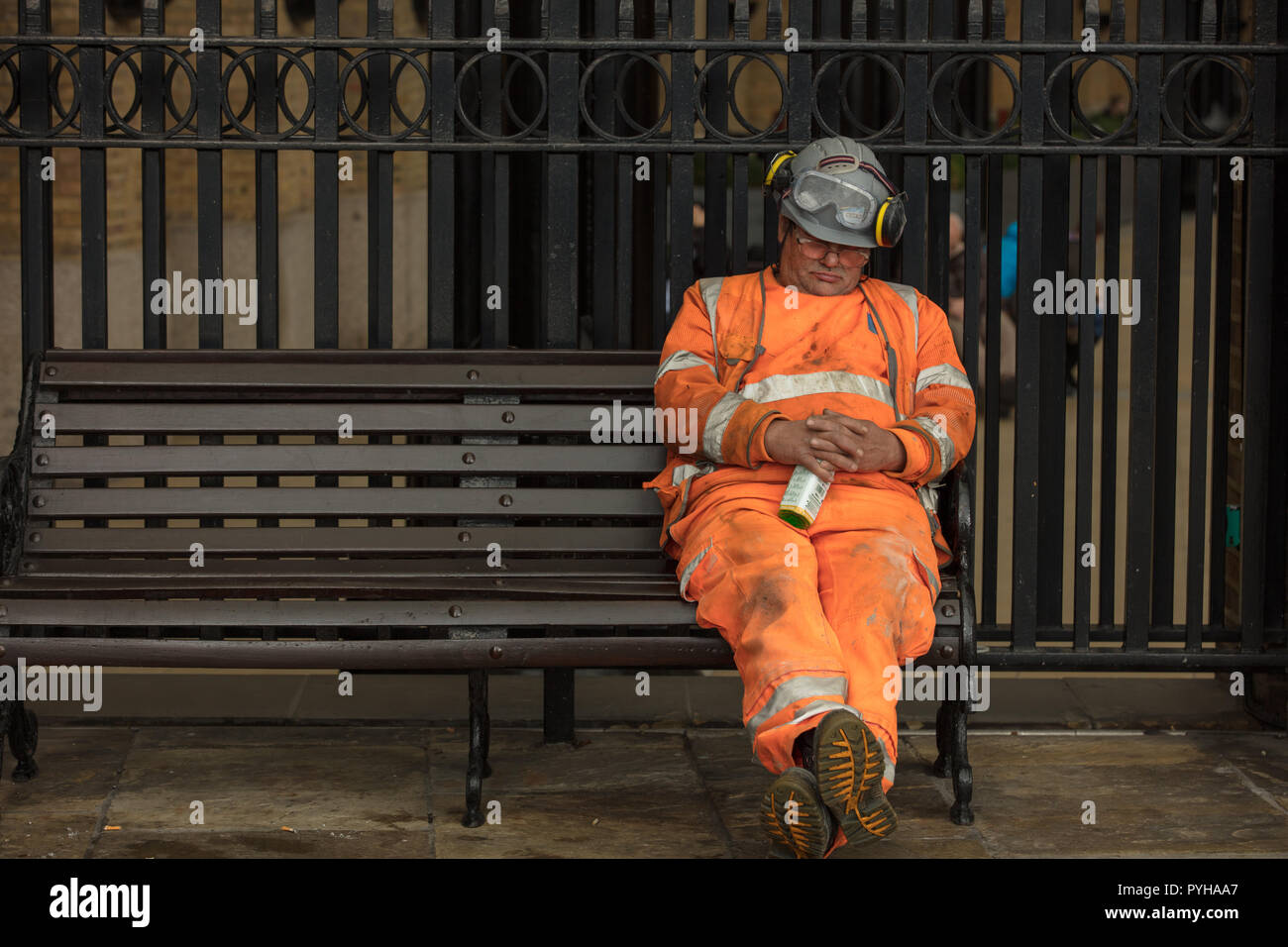 Construction worker, working in one of the new residential developments on the south bank of the river Thames, London, UK, has late afternoon nap. Stock Photo