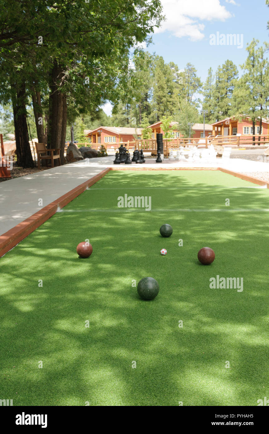 Bocce Balls, 2 red balls and 2 green balls surround the polina on a