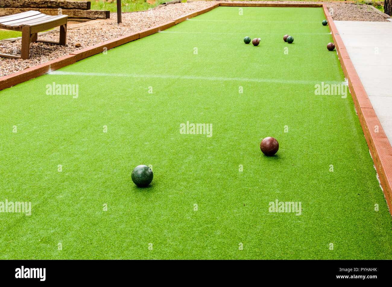 Bocce Balls surround the polina which is a small white/yellow ball on a
