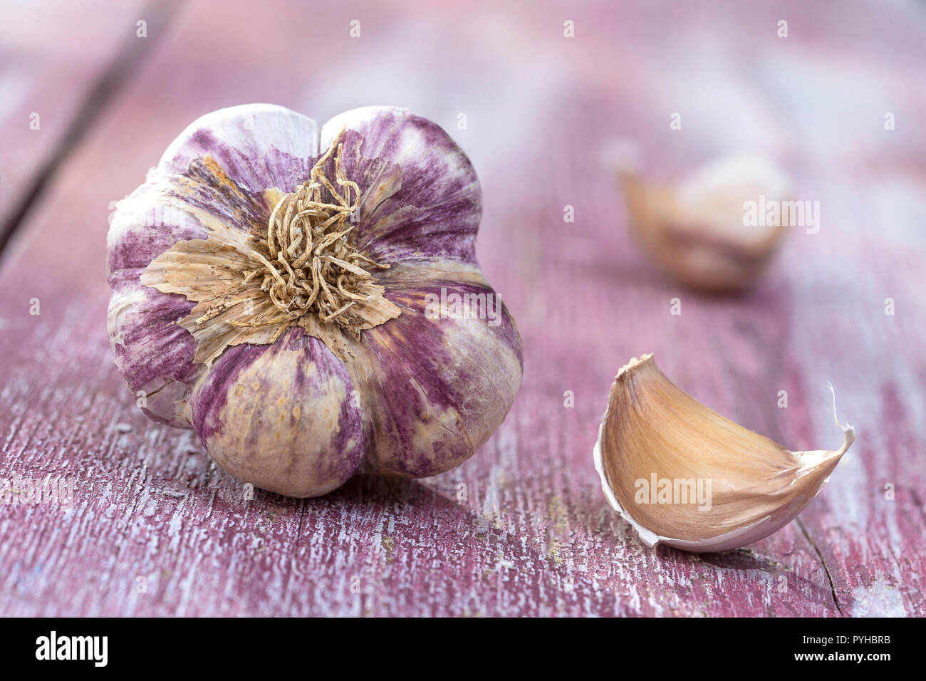 New harvest french big pink and violet garlic braid from France on pink wooden, background Stock Photo