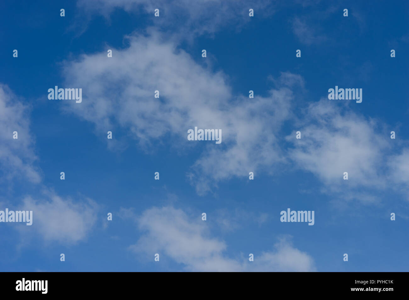 Blue sky with drifting fluffy white clouds Stock Photo