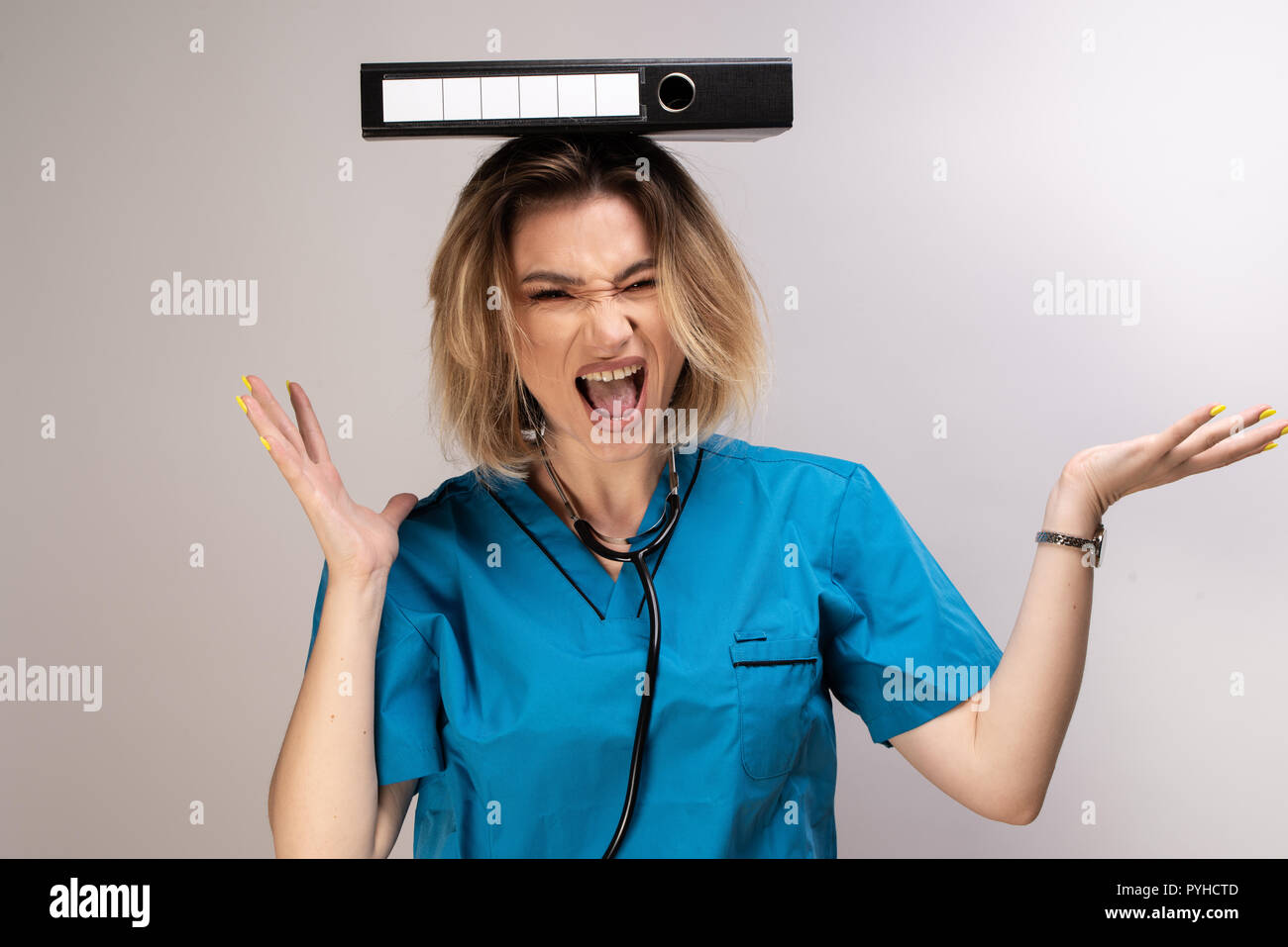 Crazy female doctor balancing documents on her head. Medicine is a fun job Stock Photo