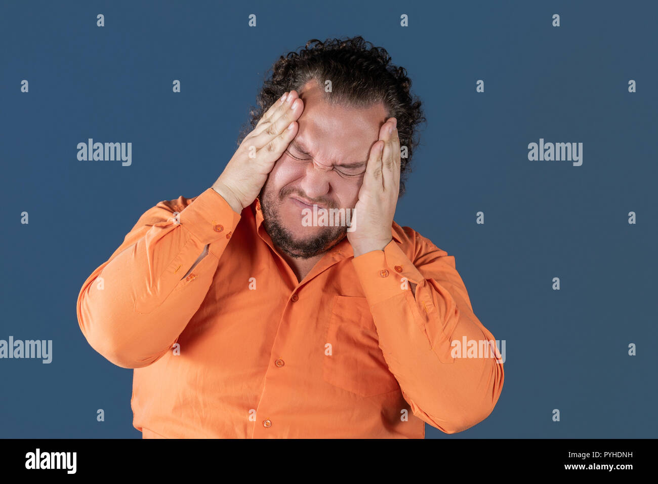 A fat man has high blood pressure and headache. Overweight and health problems Stock Photo