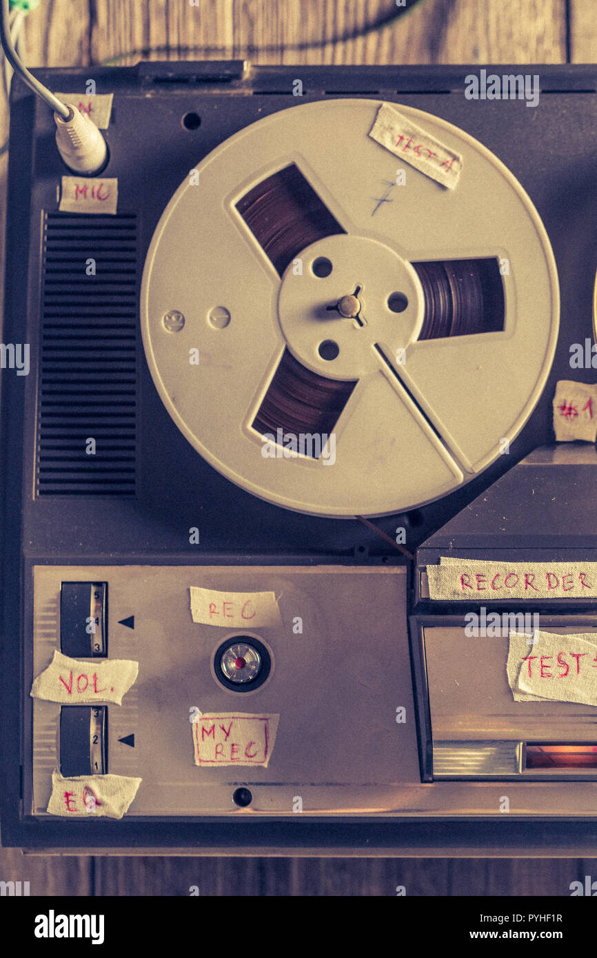 Retro reel audio recorder with microphone and roll of tape Stock Photo
