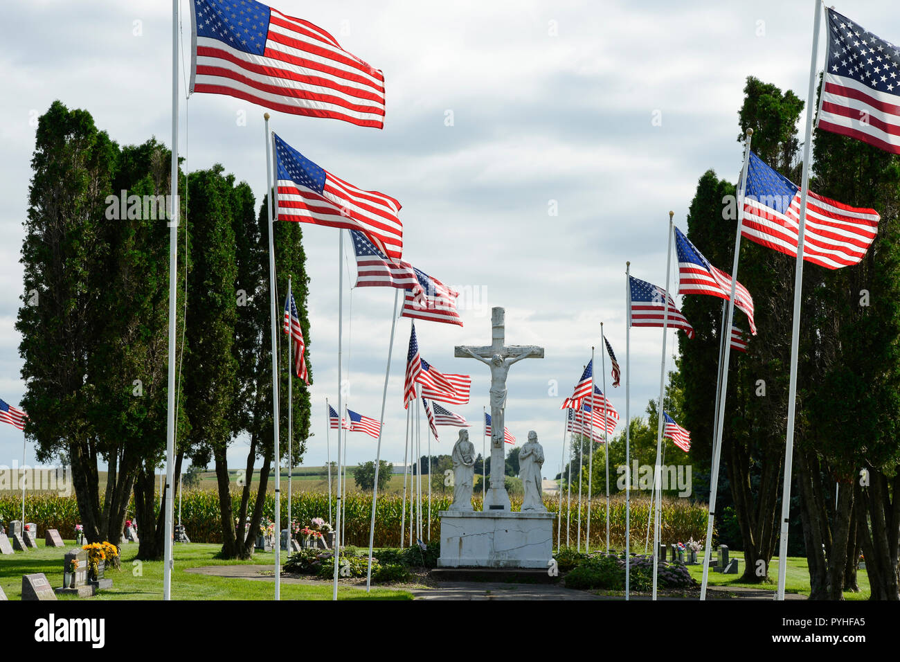 USA, Iowa, Epworth,  national flag of the United States on catholic cemetery, Jesus Christ crucified at cross, memorial day, background, backgrounds, stars and stripes Stock Photo