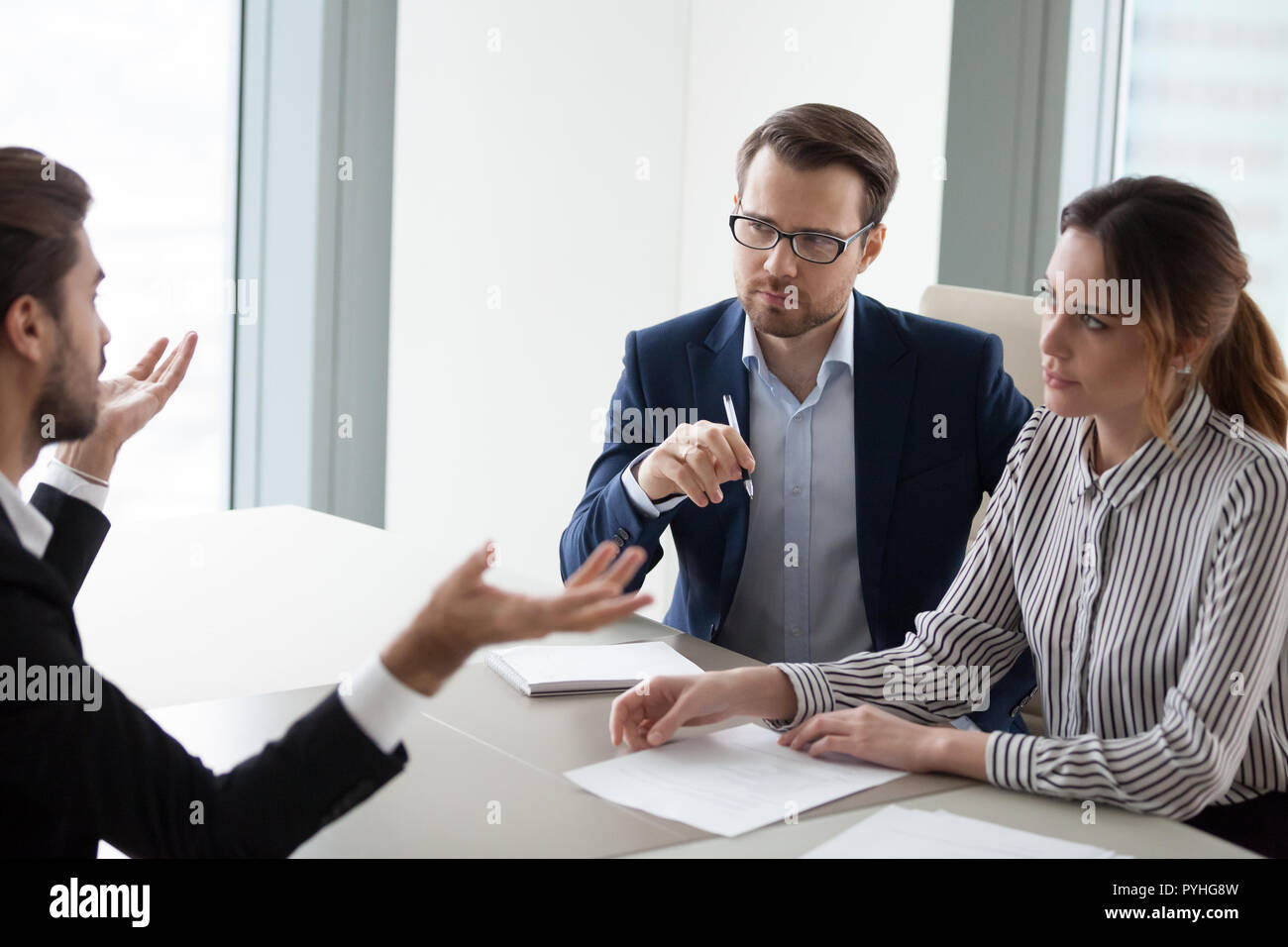 Two hr managers listen attentively to candidate for vacancy. Stock Photo