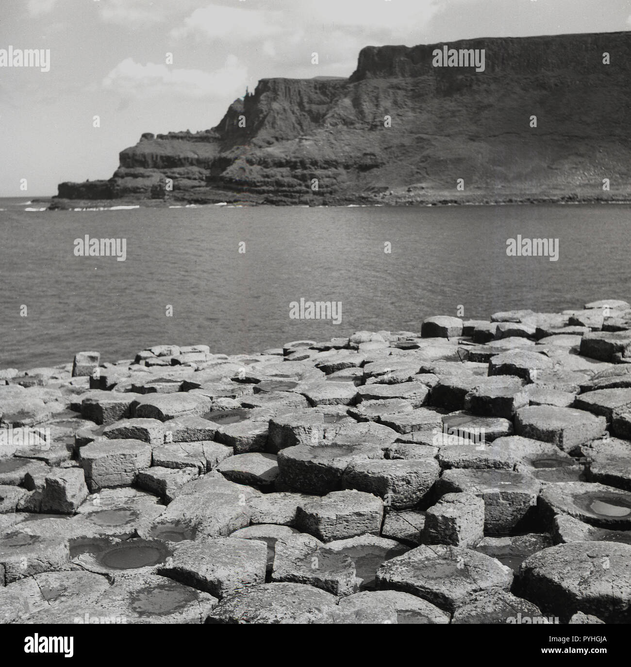 1950s, historical, the unique basalt stones at the coast at the Giant's Causeway in Co. Antrim, Northern Ireland. These basalt columns were ormed by a volcanic eruption, the rapid cooling of lava onto the earth's surface. Stock Photo