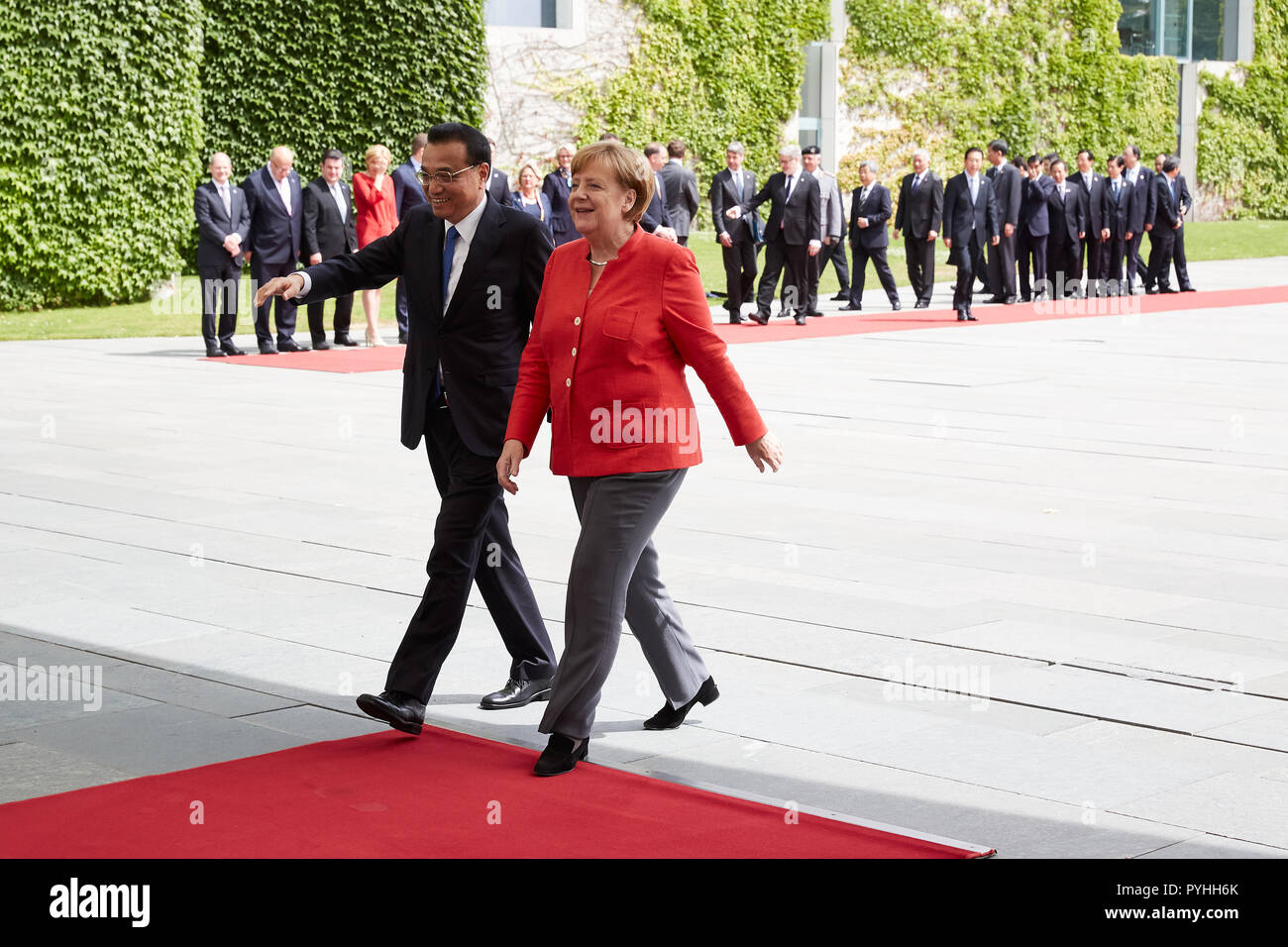 Berlin, Germany - Chancellor Angela Merkel and Chinese Prime Minister Li Keqiang leave the Chancellor's Court of Honour after receiving military honours. Stock Photo