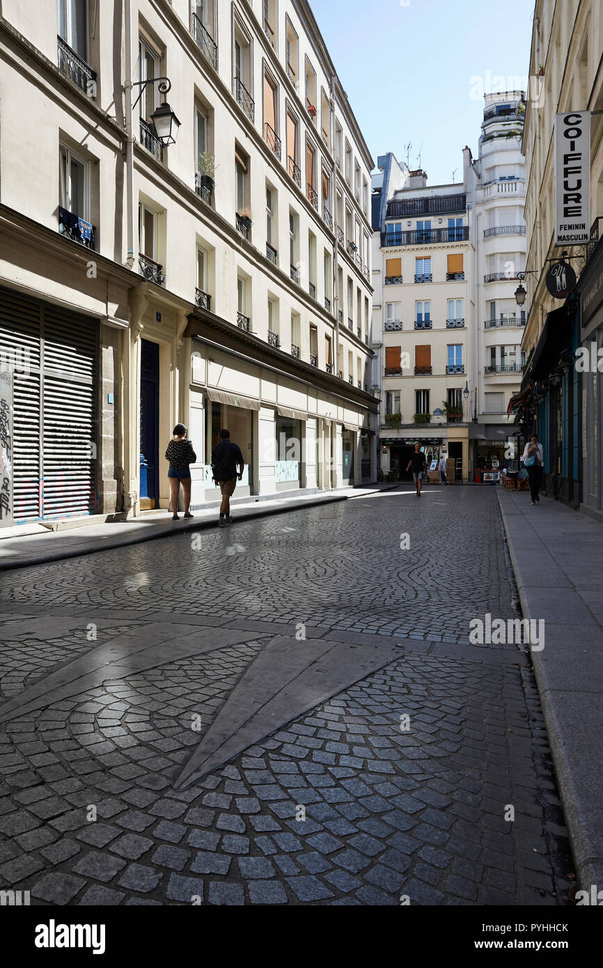 Paris, Ile-de-France, France - Small shops in historic residential buildings dominate the picture on Rue Mandar in the 2nd arrondissement. Stock Photo
