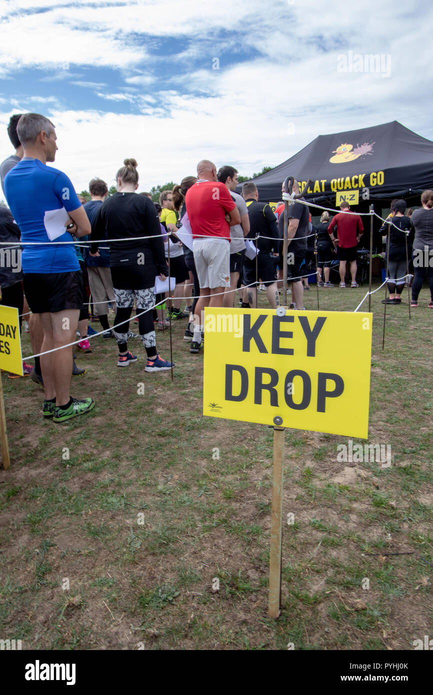 At an obstacle course race a key drop so you don't lose them in the mud Stock Photo