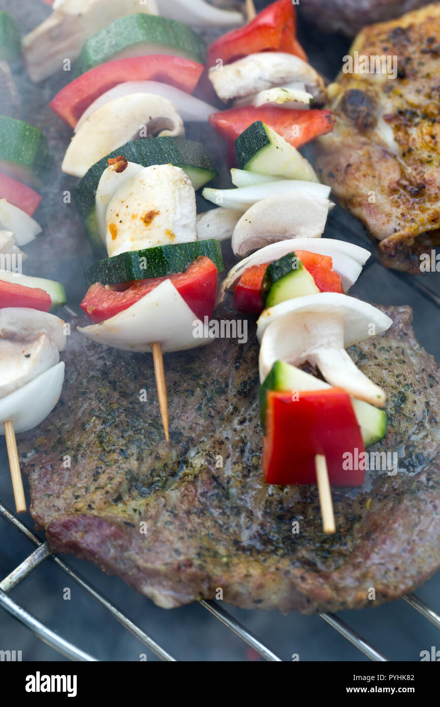 barbecue with delicious grilled meat and vegetables on grill Stock ...