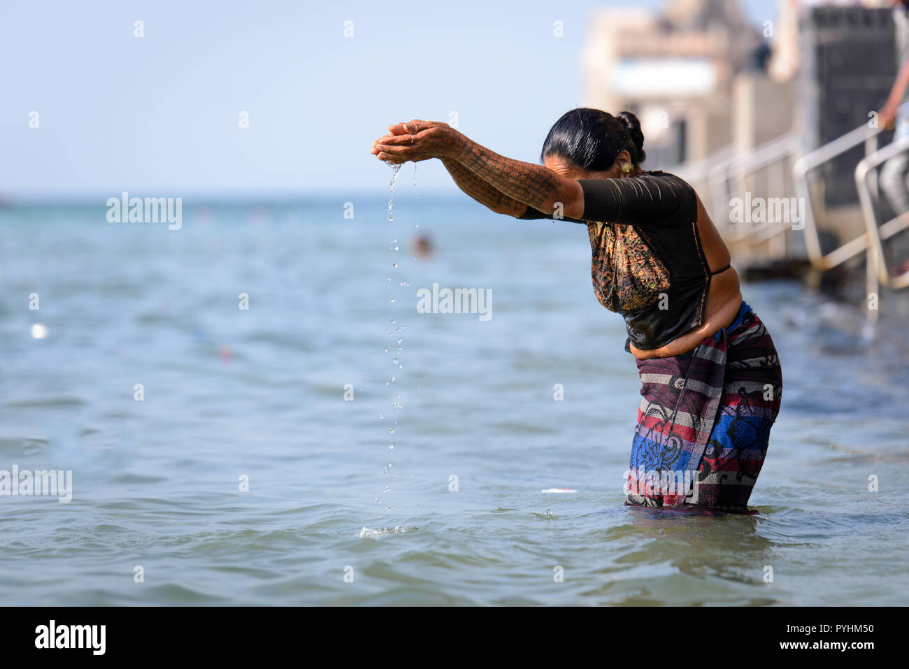 Indian Hindu woman taking a dip in the holy Gomti river at the town of