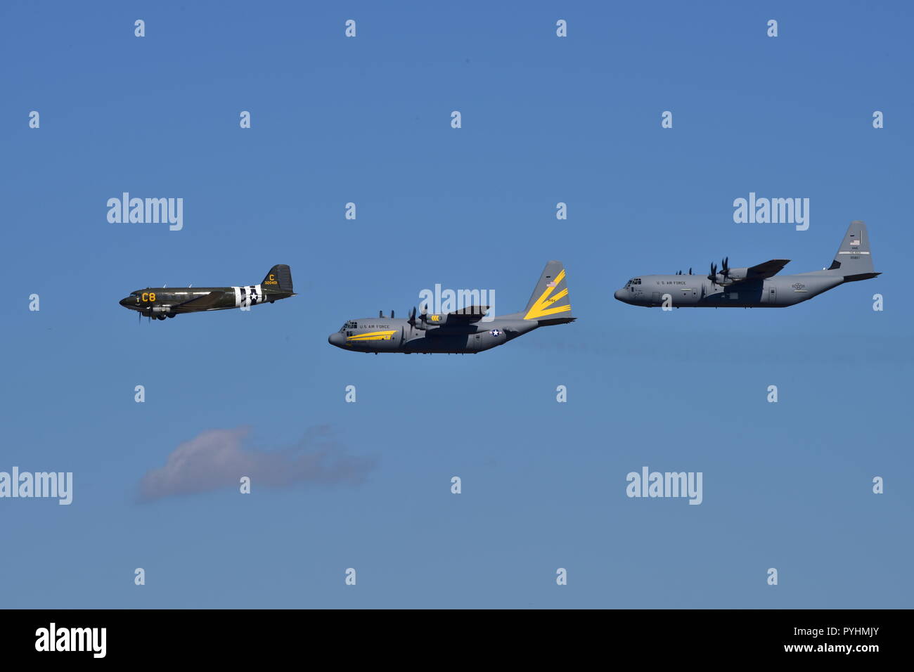 A Douglas C47 Skytrain, a C130H and a C130J fly in formation during