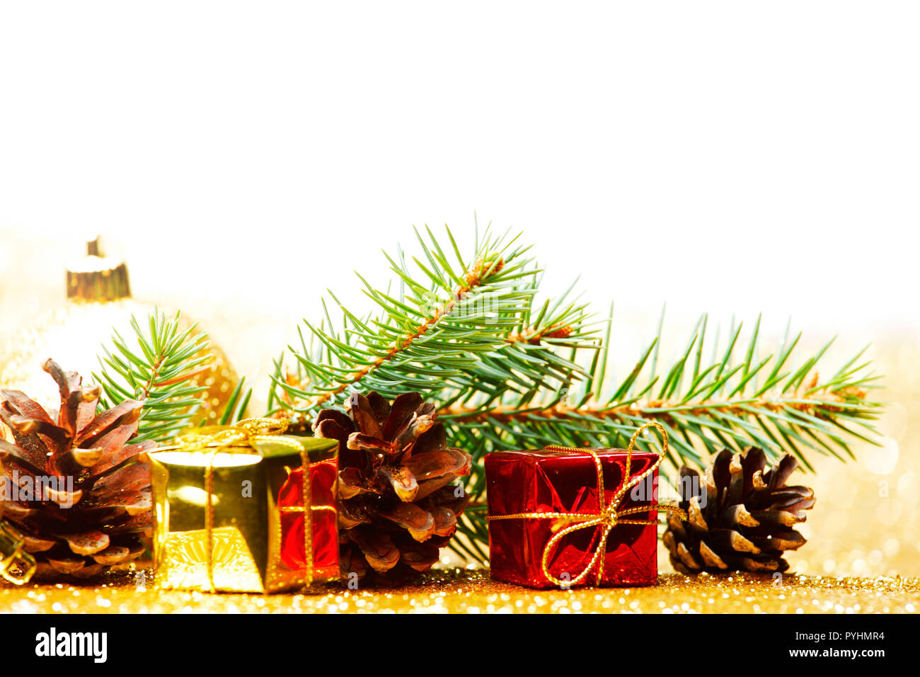 Christmas card with fir branch and decorations on golden gitter ...