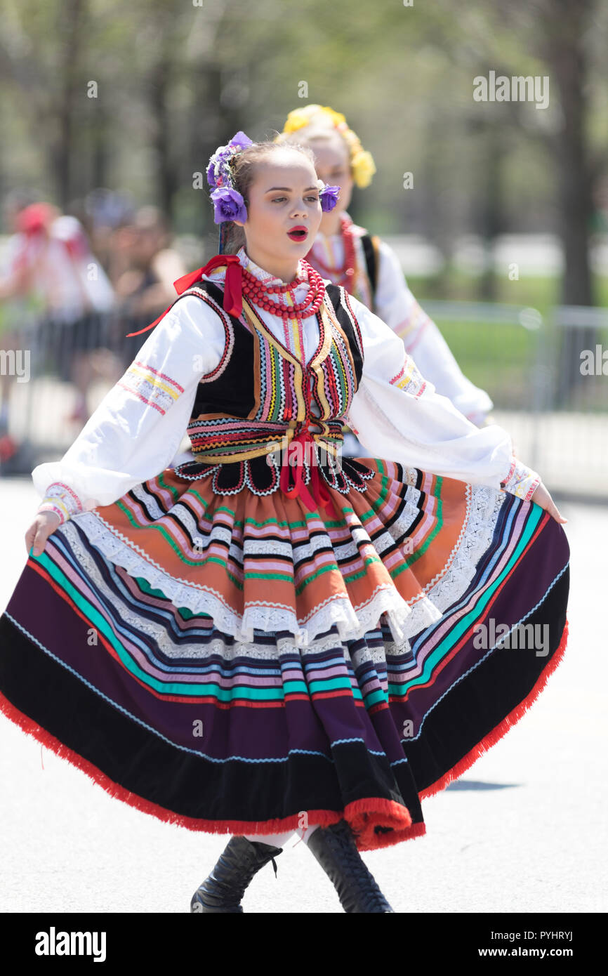 Chicago, Illinois, USA - May 5, 2018: The Polish Constitution Day Parade, Polish woman wearing traditional clothing dancing during the parade Stock Photo