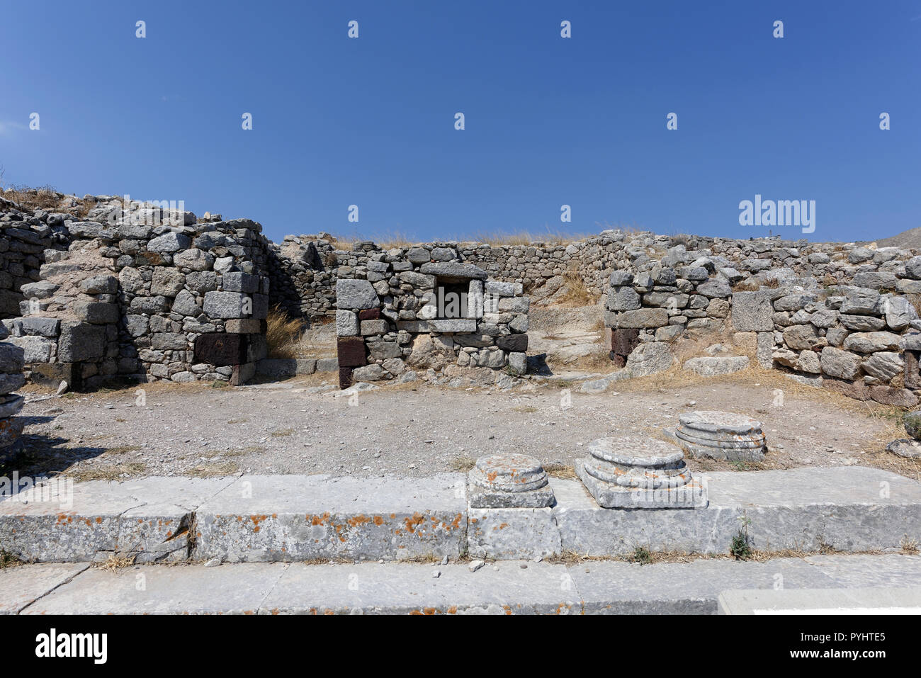 Ruins of the once imposing porticoed courtyard entrance to the Ptolemaic garrison post, ancient city of Thera, Santorini, Greece. The building dates f Stock Photo
