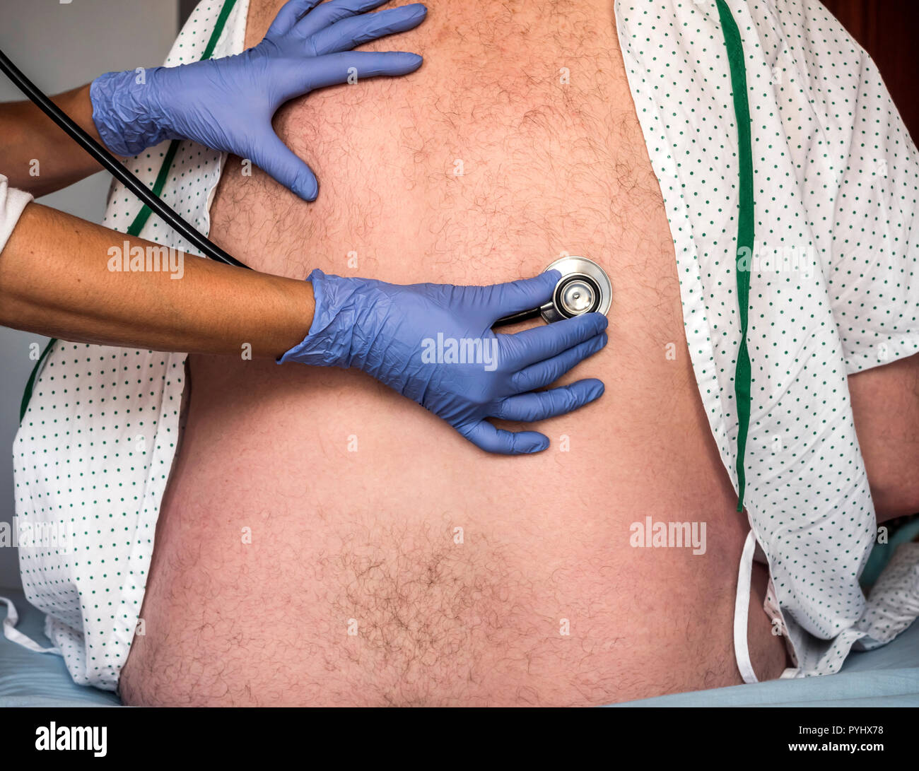 doctor auscultating young patient with the stethoscope Stock Photo