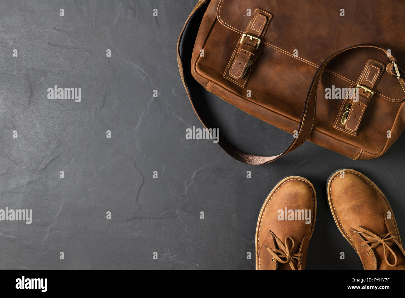 Leather Vintage business bag and leatrher Casual Shoes on black stone background with copy space, accessories costume concept Stock Photo