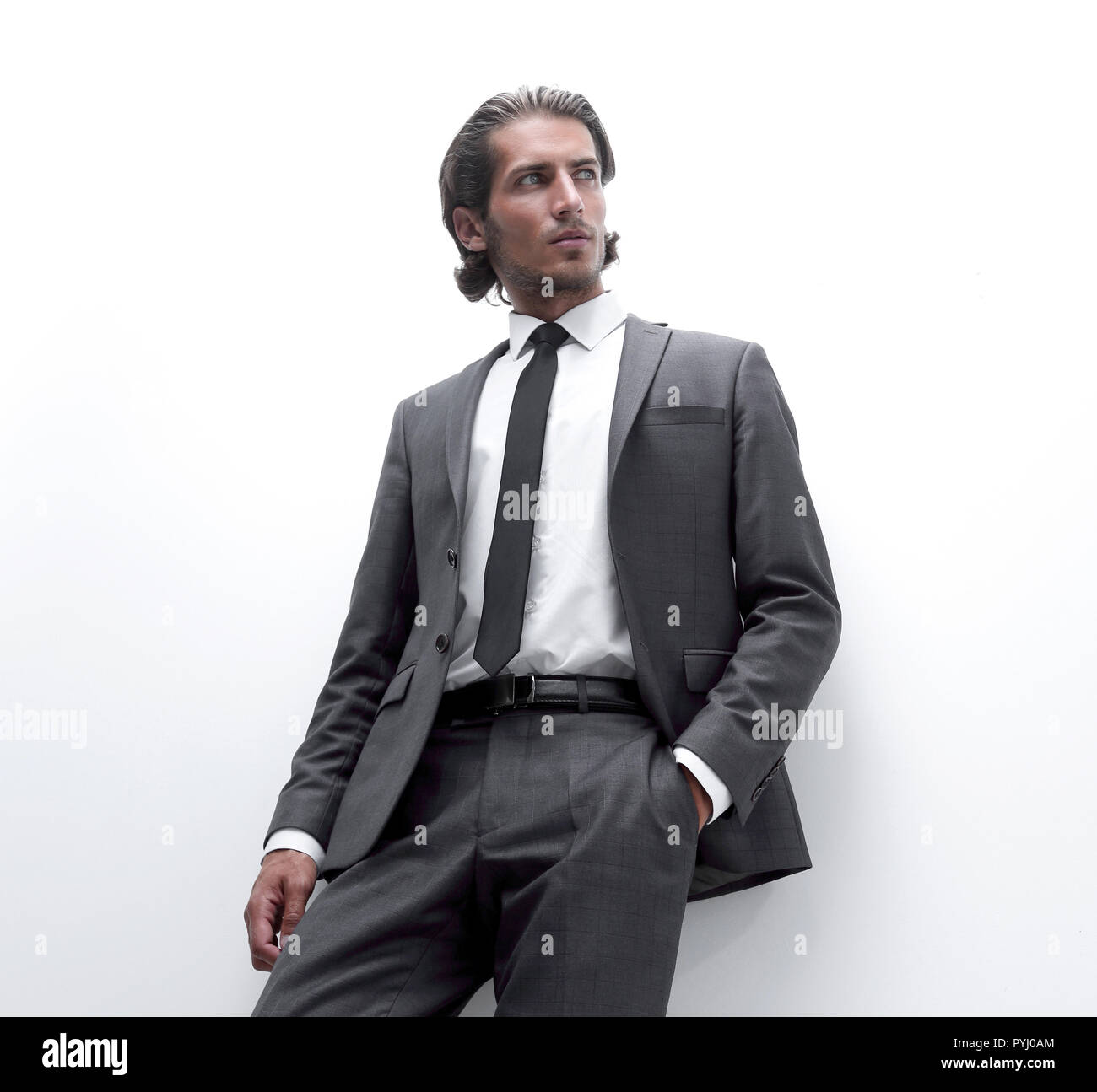 businessman is leaning on a white wall Stock Photo