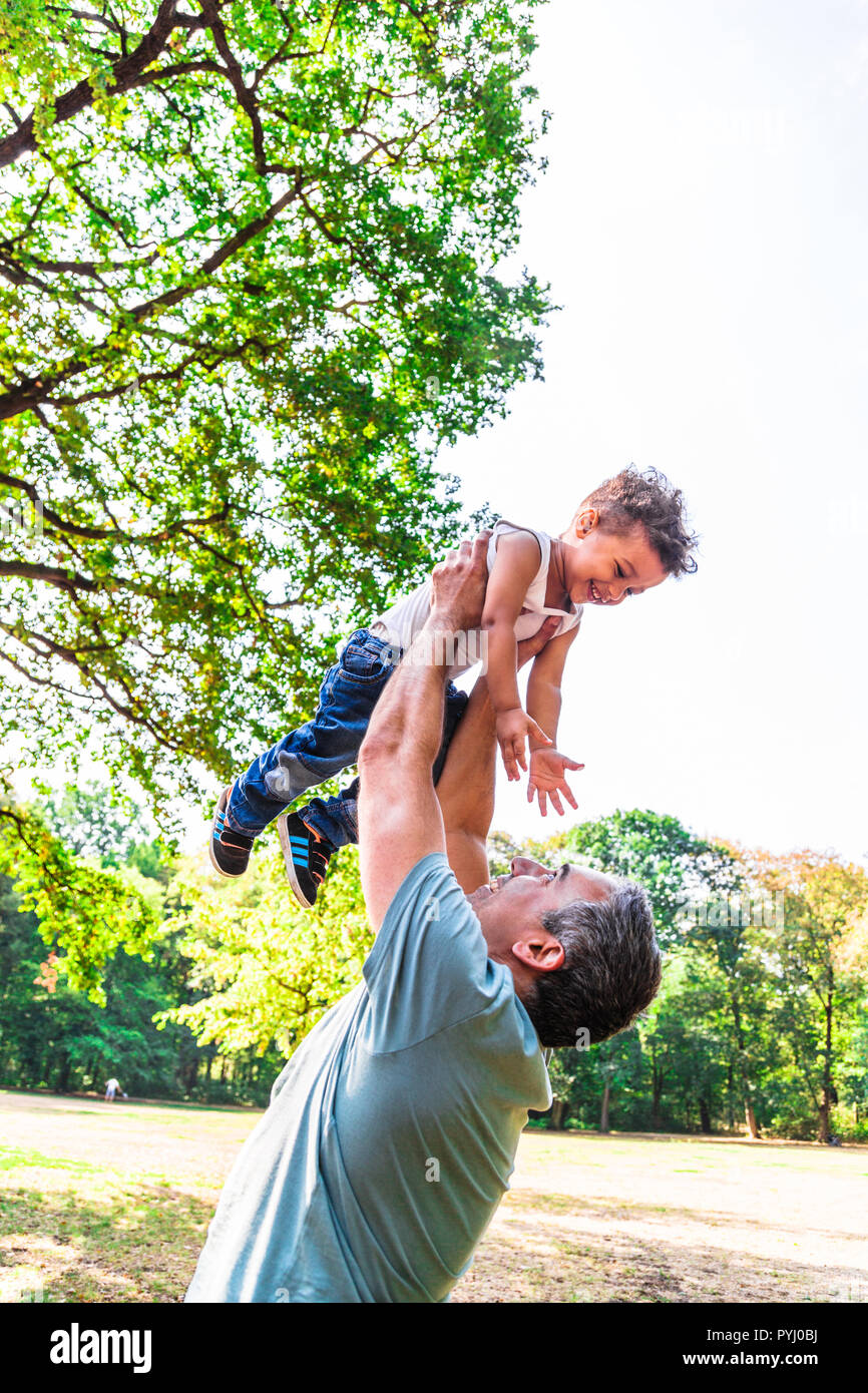 Father throwing his child in air. Happy childhood Stock Photo Alamy