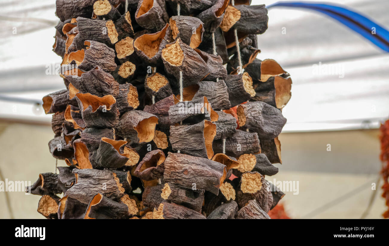 Dried Cinnamon on strings above market stall in Turkey Stock Photo