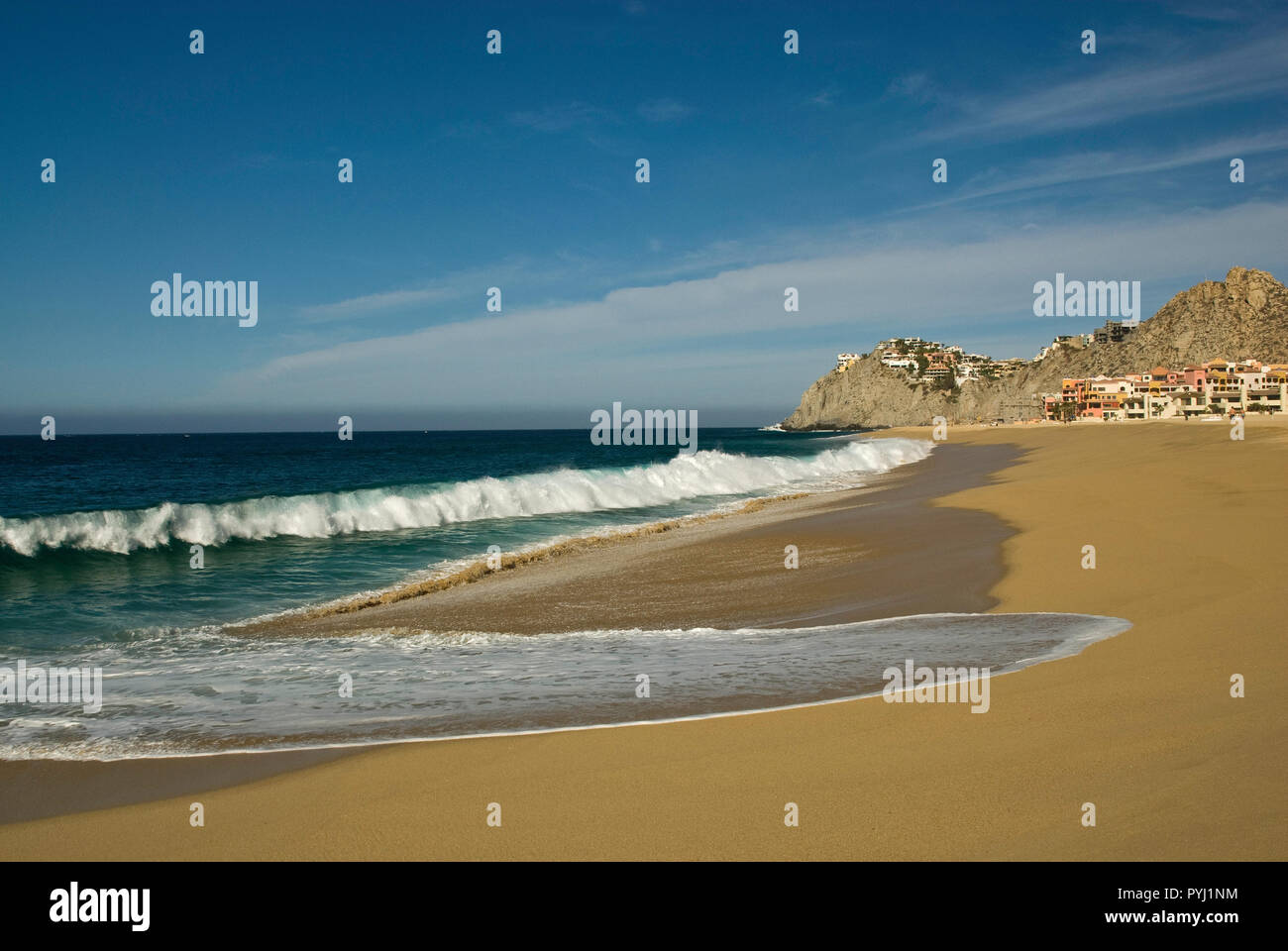 Huge Pacific Ocean waves, hotels in distance at Playa Solmar at Cabo San Lucas, Baja California Sur, Mexico Stock Photo