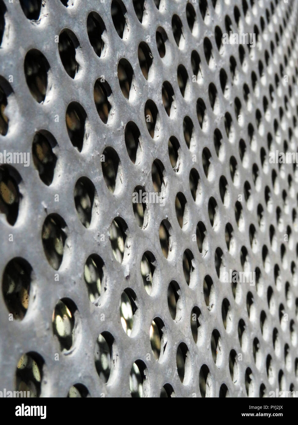 Galvanized Metal Security Grill Mesh Sheet With Holes Making Graphic Shapes Stock Photo Alamy