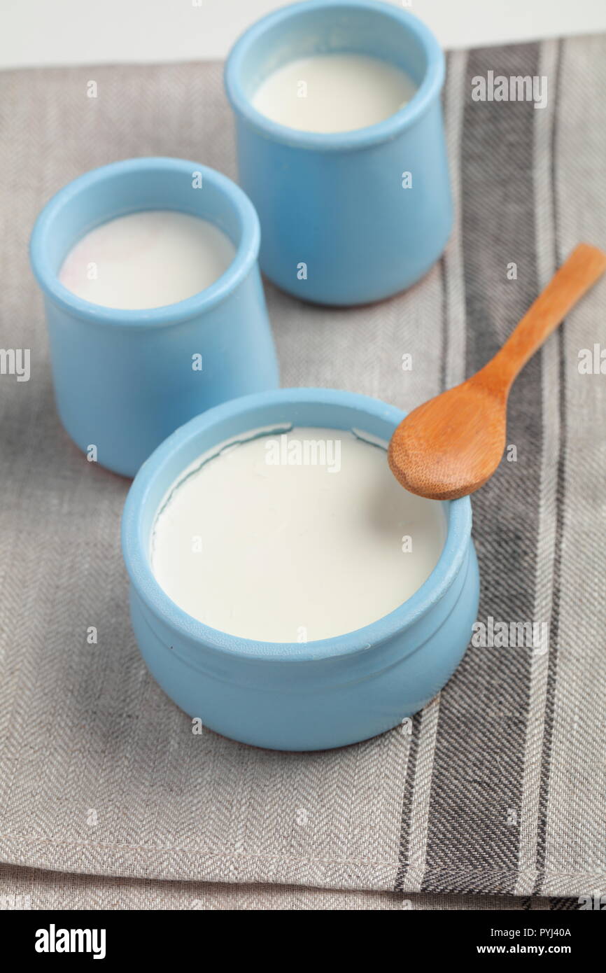 Natural yogurt and sour cream in blue pots Stock Photo - Alamy