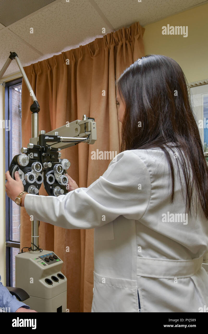 woman ophthalmologist with machine phoropter Stock Photo