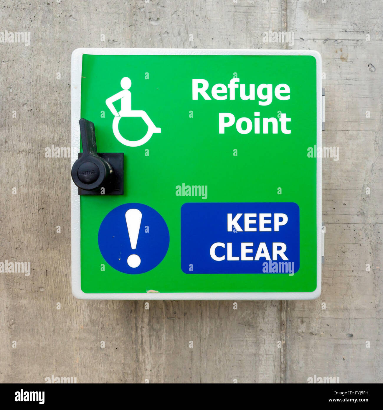 Refuge Point notice and latch providing  emergeny access for wheelchairs on an external walkway Stock Photo
