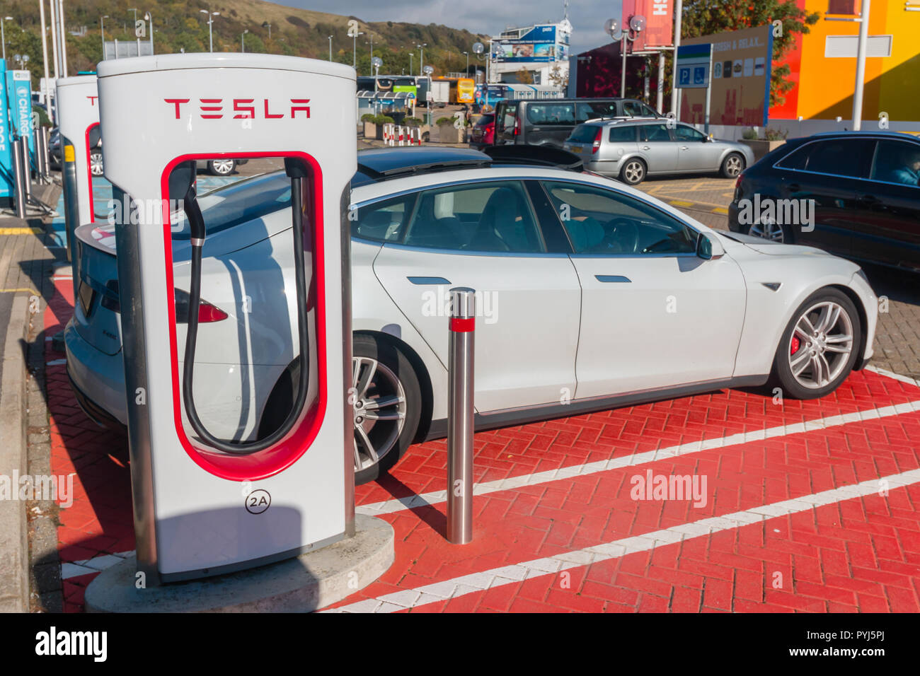 A Tesla car using a 'supercharger' parking spot Stock Photo