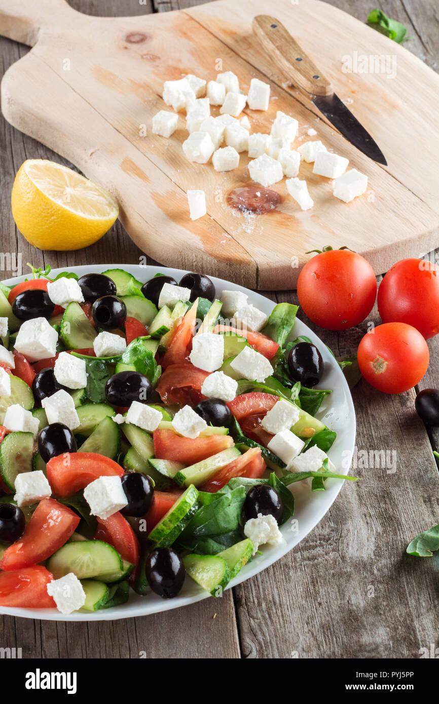 Greek salad closeup. Ingredients in background Stock Photo