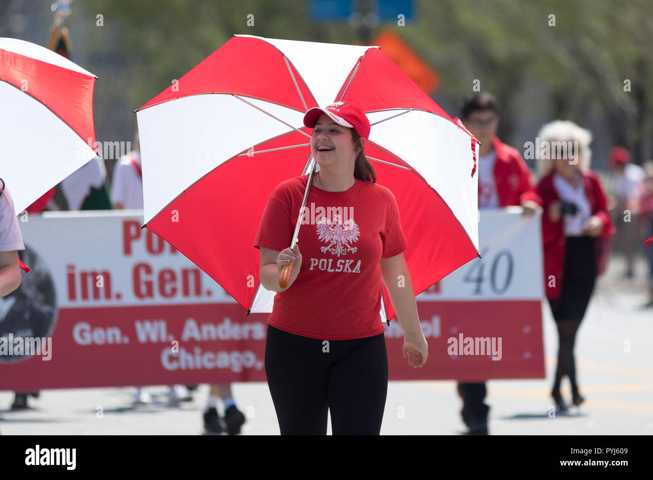 Chicago, Illinois, USA - May 5, 2018: The Polish Constitution Day Parade, Polish woman wearing a shirt that says polska and using an umbrella with the Stock Photo