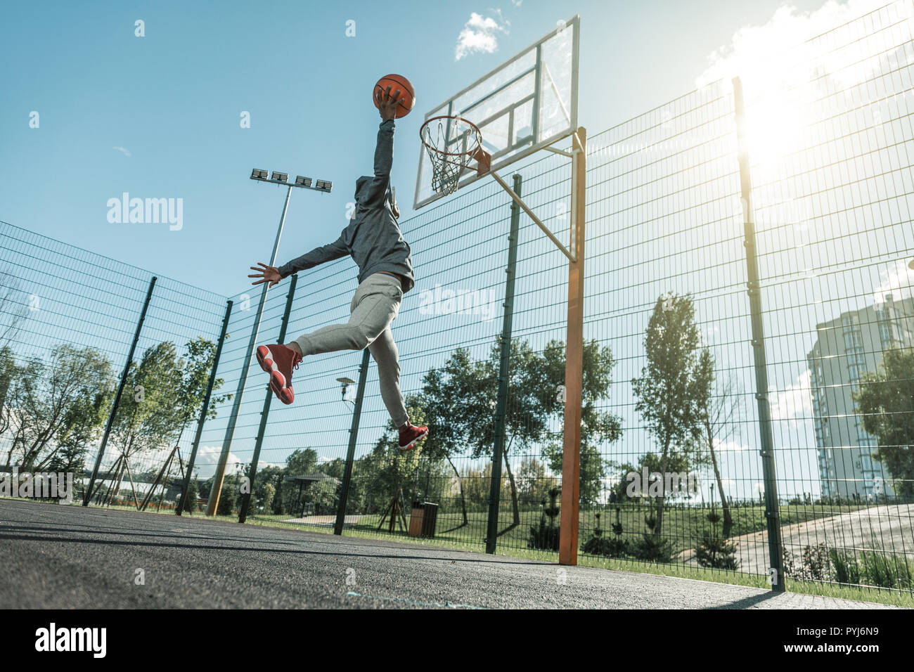 Low angle of a nice young man throwing the ball Stock Photo Alamy