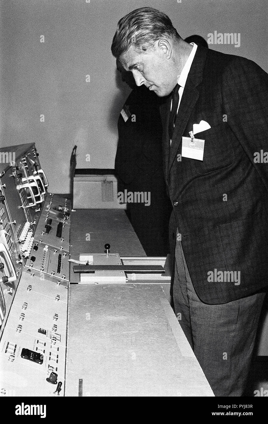 This photograph, dated October 14, 1964, was taken at the Marned Spacecraft Center, now the Johnson Space Center in Houston, Texas. Dr. von Braun is shown looking over consoles in the Manned Spaceflight Control Center. Stock Photo