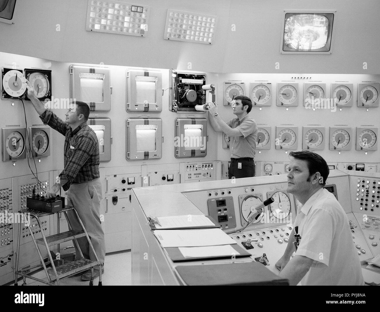 Donald Rhodes, left, and Clyde Greer, right, monitor the operation of the National Aeronautics and Space Administration’s (NASA) Plum Brook Reactor Facility from the control room. Stock Photo