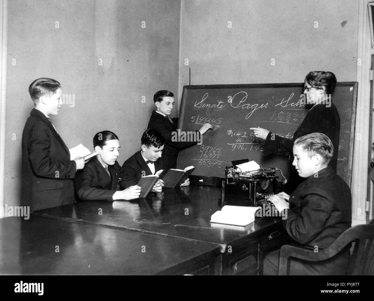 Teacher and five boys in Senate Pages' School - boy typing ca. 1909-1932 Stock Photo