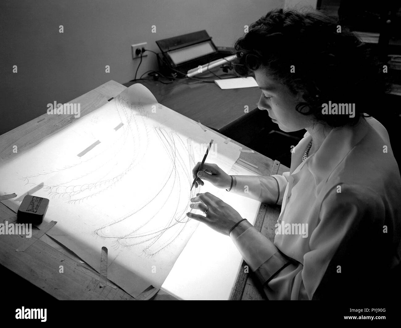 The Computing Section was introduced during World War II to relieve short-handed research engineers of some of the tedious data-taking work. The computers made the initial computations and plotted the data graphically. The researcher then analyzed the data and either summarized the findings in a report or made modifications or ran the test again. Stock Photo