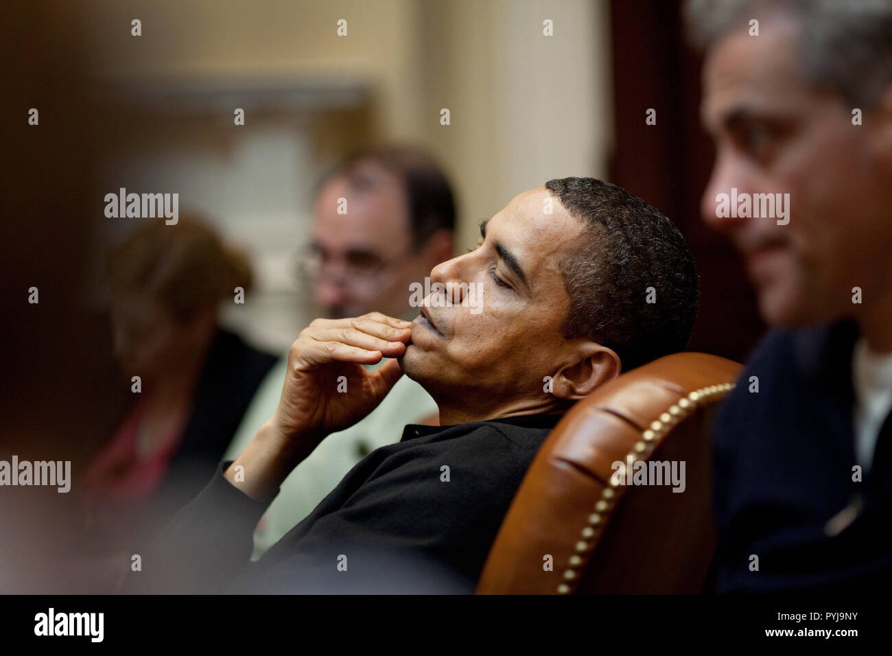 President Obama reflects during an economic meeting with advisors