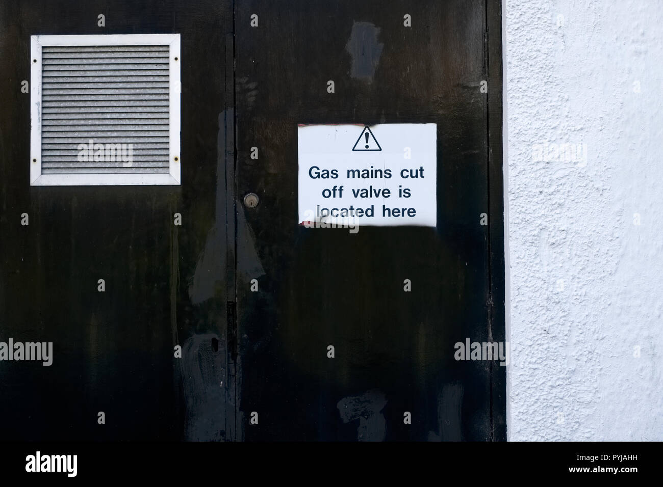 Gas valve main location plan safety sign on boiler house door with air grille Stock Photo