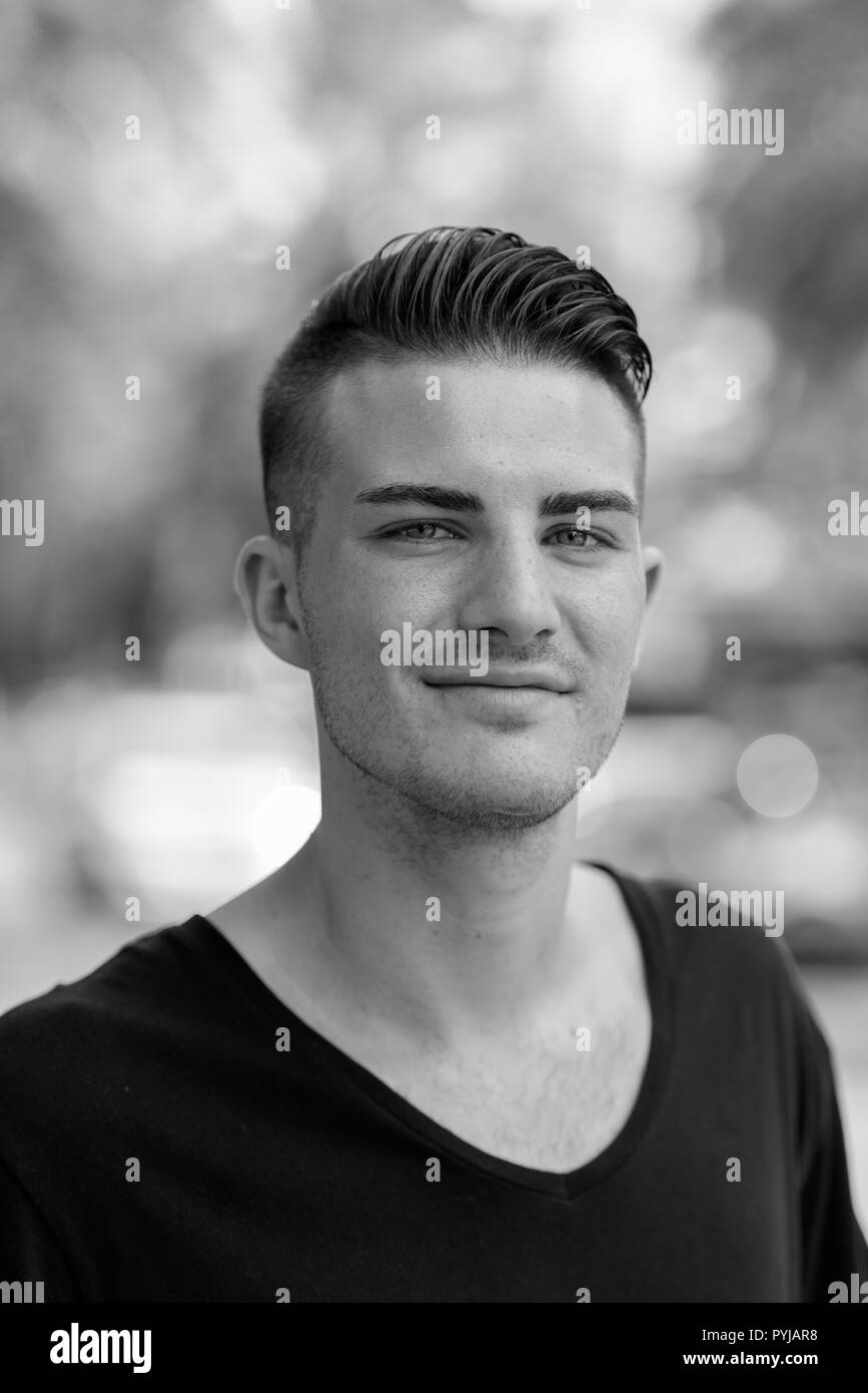 Black and white portrait of young handsome man outdoors Stock Photo