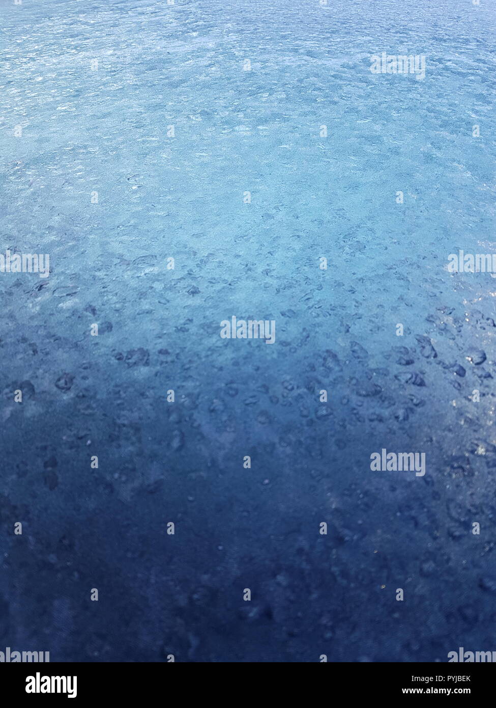 Frost Pattern on Frozen Glass Focused on Background Stock Photo