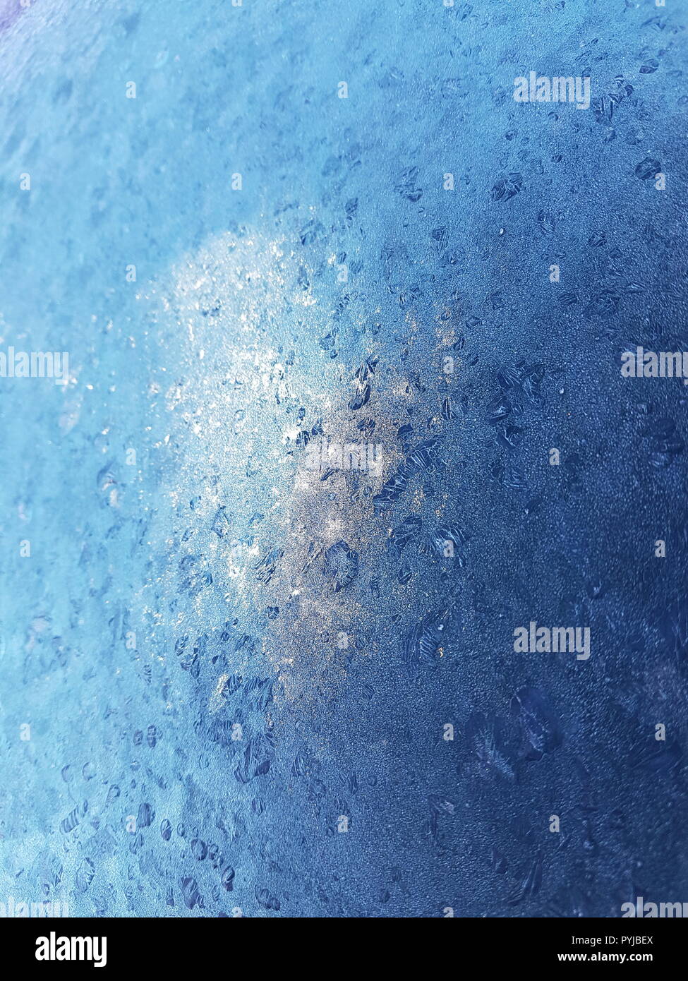 Frost pattern on Frozen covered Glass with Light Reflection Stock Photo