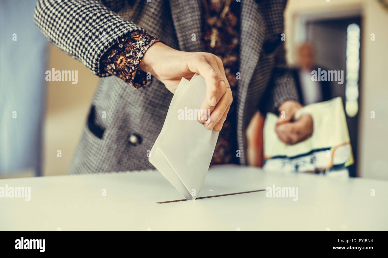 Polling Ballet Color image of a person casting a ballot at a polling station, during ...