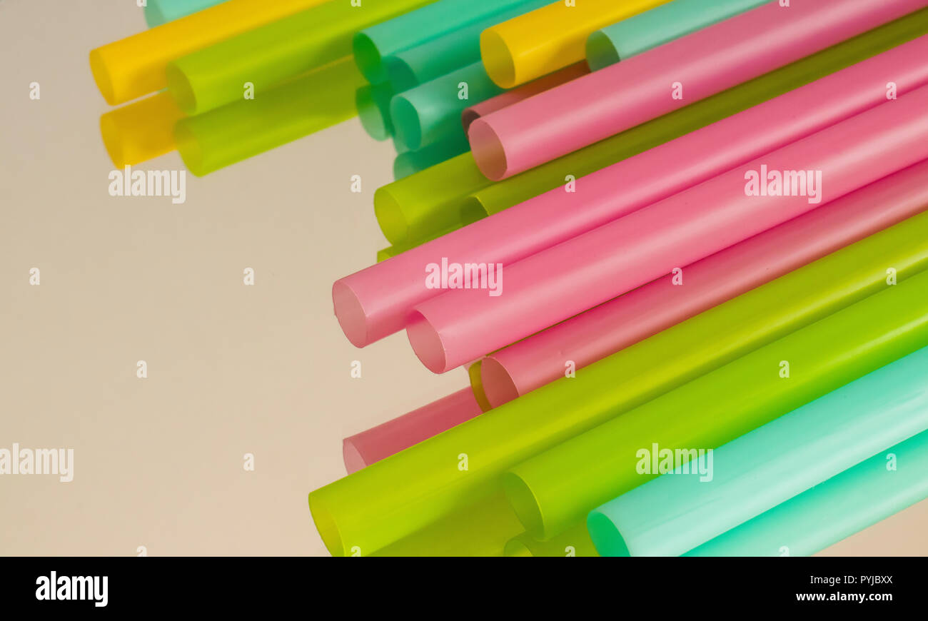 Multicoloured plastic straws on a mirrored surface Stock Photo