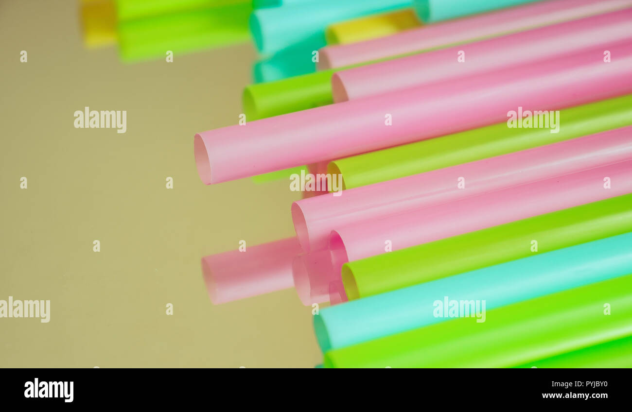 Multicoloured plastic straws on a mirrored surface Stock Photo