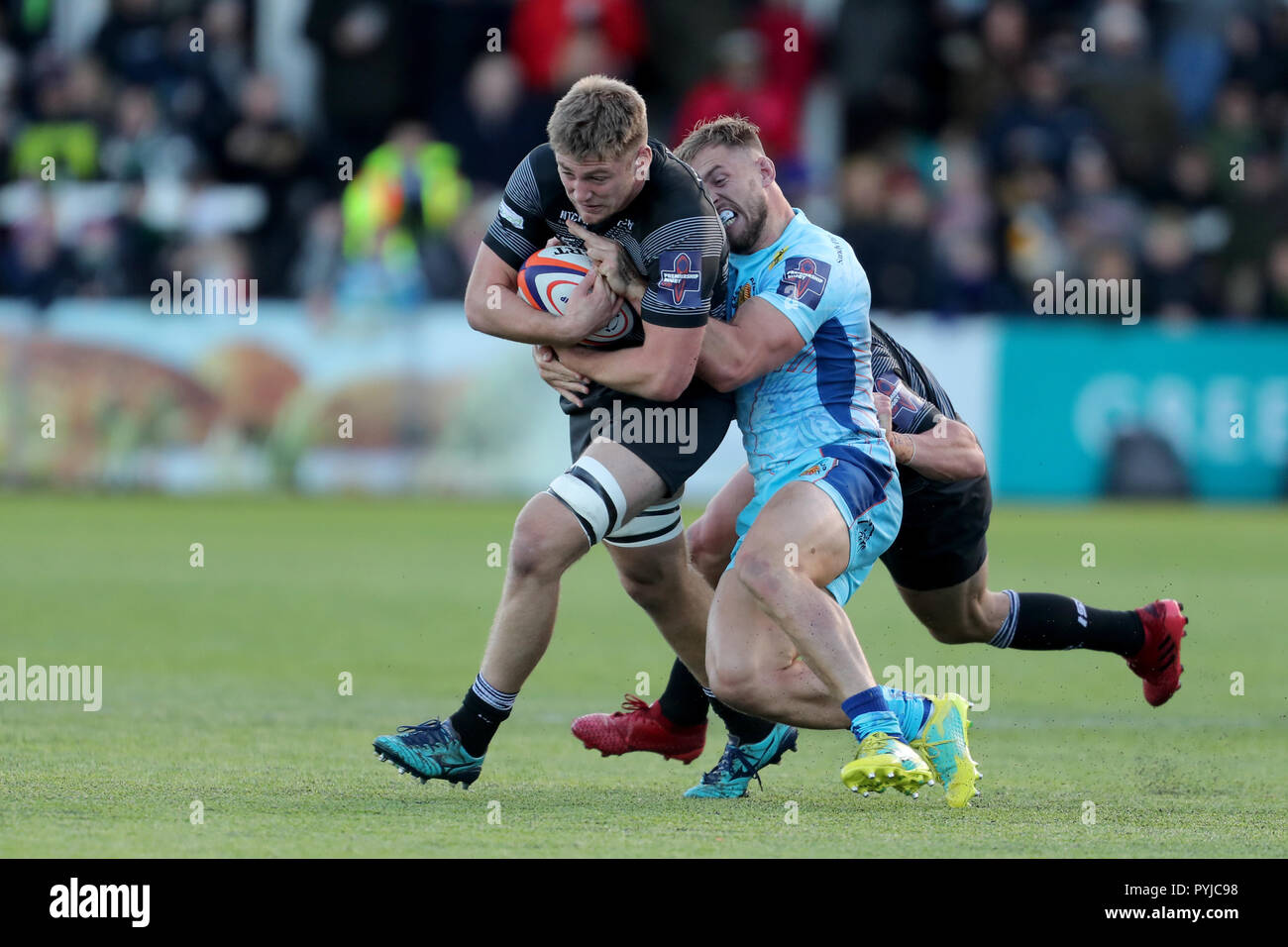 Exeter Chiefs Sam Hill tackles Newcastle Falcons Glen Young during the Premiership Rugby Cup match at Kingston Park, Newcastle. Stock Photo