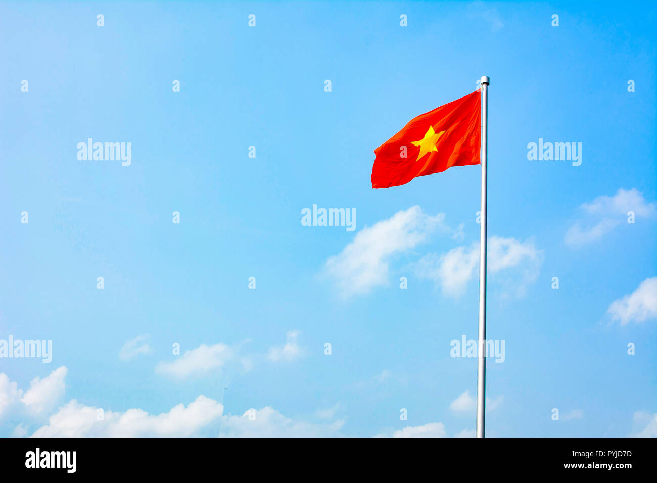 Republic of Vietnam flag winding in the wind against blue sky Stock Photo
