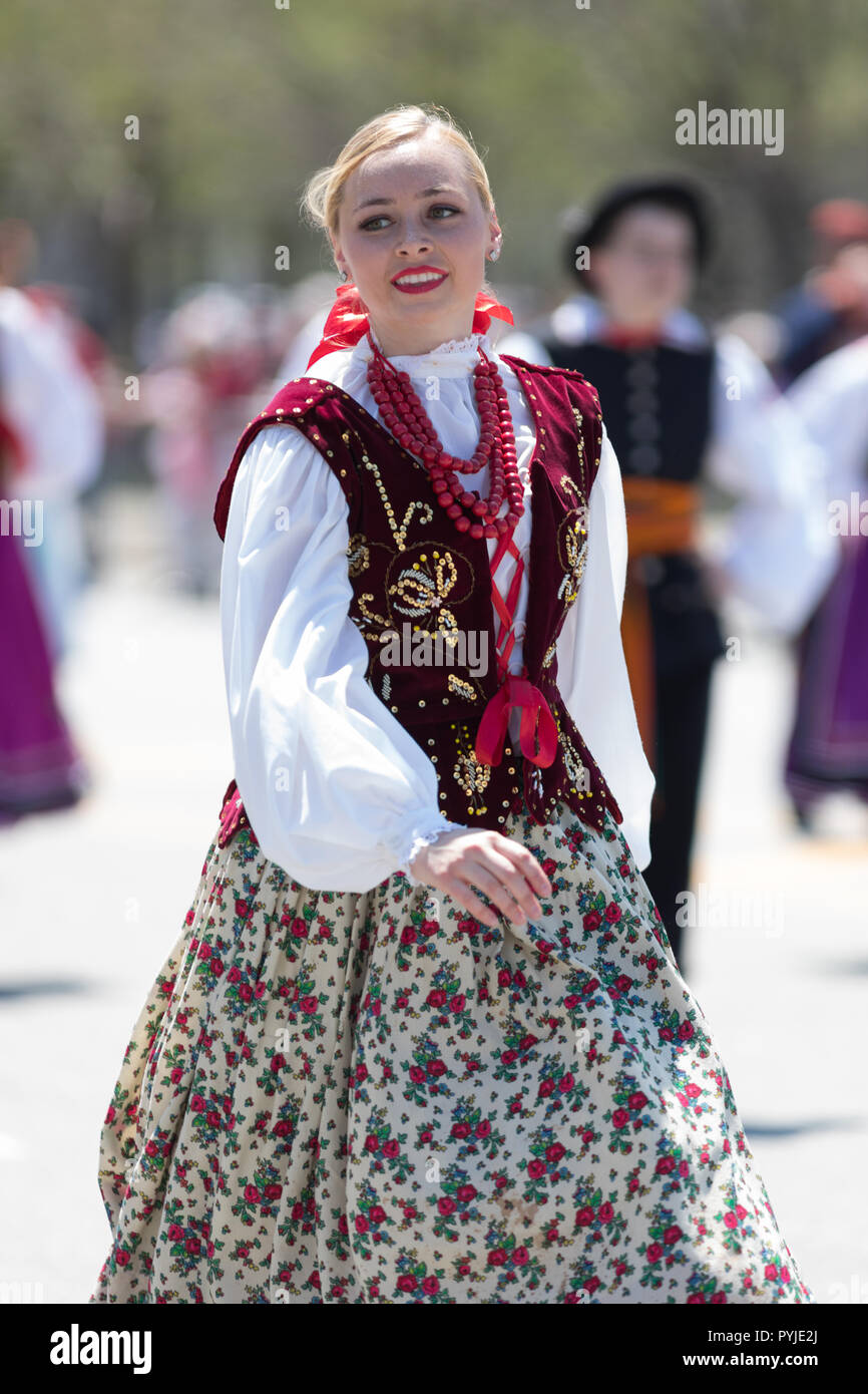 Chicago, Illinois, USA - May 5, 2018: The Polish Constitution Day Parade, Polish woman wearing traditional clothing dancing during the parade Stock Photo